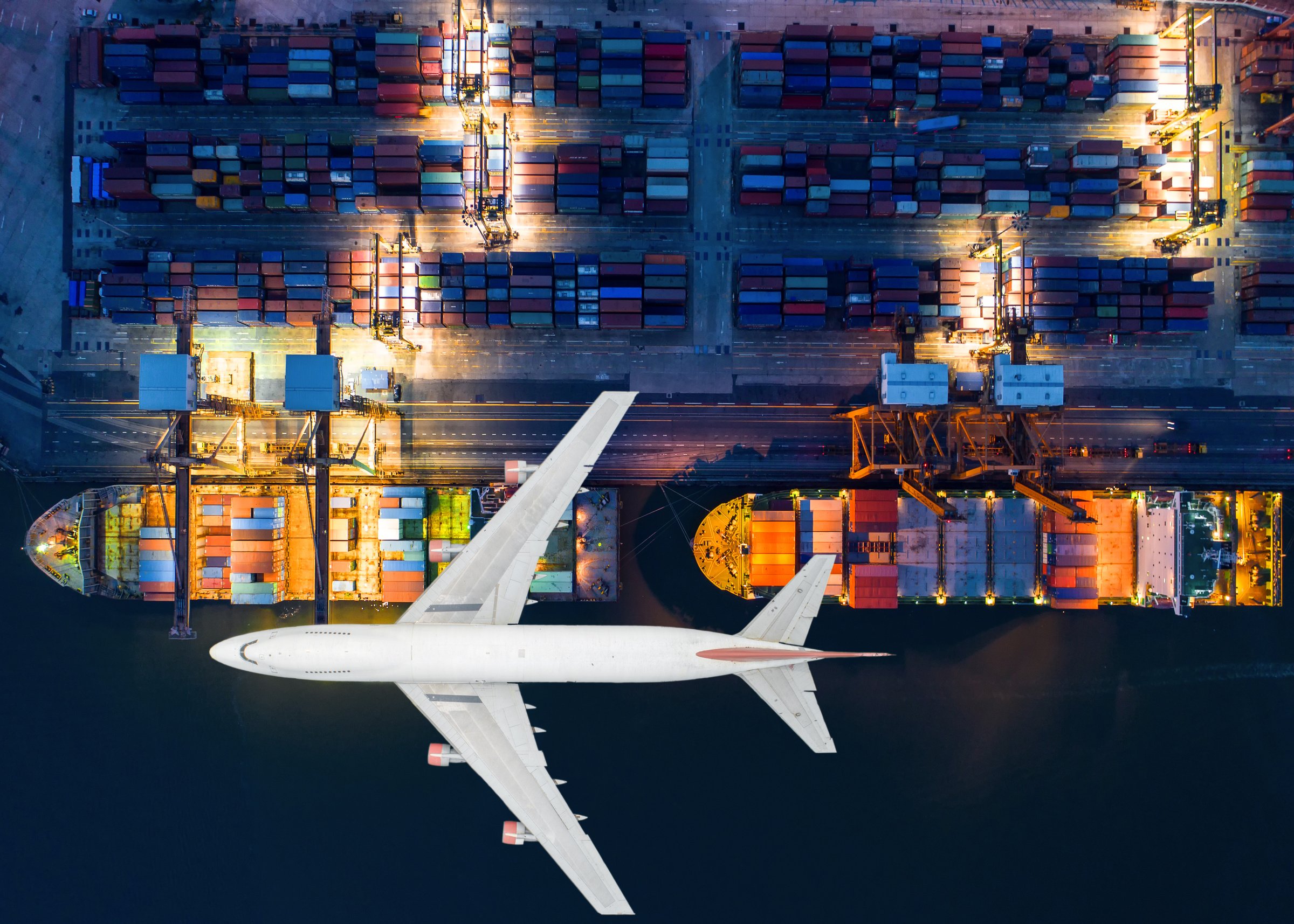 Container ship and transport aircraft in export and import business and logistics. Shipping cargo to harbor by crane. Water transport International. Aerial view and top view.